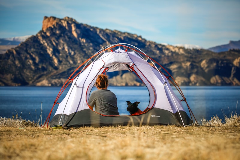 A cozy sleeping bag and pillow laid out inside a tent in soft morning light.